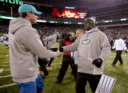 New York Jets head coach Todd Bowles, right, greets Miami Dolphins head coach Adam Gase at mid field after an NFL football game, Saturday, Dec. 17, 2016, in East Rutherford, N.J. The Dolphins won 34-13. (AP Photo/Adam Hunger)